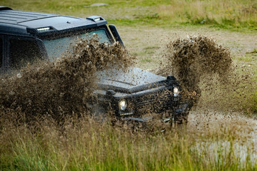 Off-road vehicle stuck on impenetrable road after rain in the countryside. Travel and racing concept for 4x4 drive off road vehicle. © Volodymyr