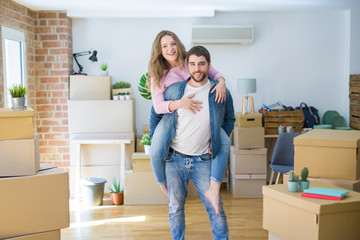 Young couple moving to a new house, boyfriend giving a piggy back ride to girlfriend, very happy and cheerful for new apartment