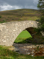 Fototapeta na wymiar landscape with a beautiful arched stone bridge