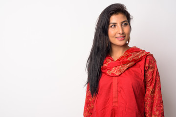 Naklejka premium Face of happy young Persian woman thinking in traditional clothing