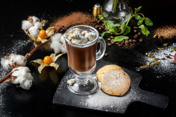 Chocolate dessert, hot chocolate with ice cream pieces, around a beautifully decorated table.
