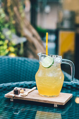 Honey and lemon iced tea with tiny dressert on the table.