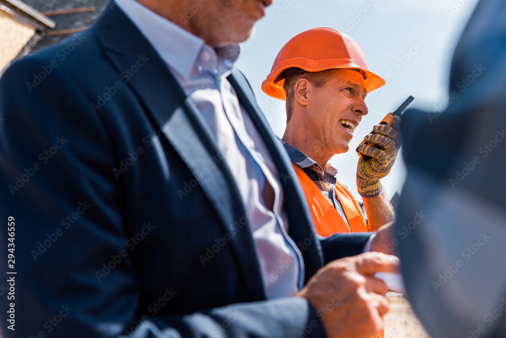 Wall mural selective focus of architect using walkie talkie near businessman