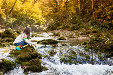 Outdoor recreation and awesome adventures with kids. A little child girl is walking along a green...