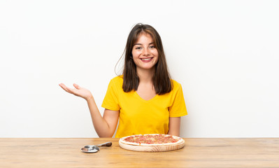 Caucasian girl with a pizza holding copyspace imaginary on the palm