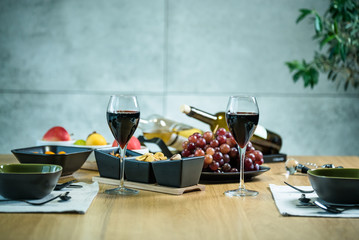 Pouring wine into glass and food background