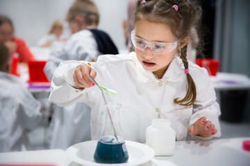 Helsinki, Finland: Finnish science center Heureka in Vantaa. Children's chemical laboratory in the scientific-interactive Museum. A little girl is passionate about chemical experiments
