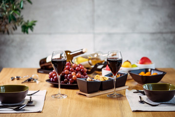 Pouring wine into glass and food background