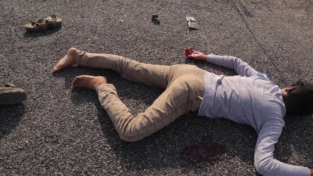 Crime Scene concept, Establishing shot of dead body laying on road at hot sunny day.
