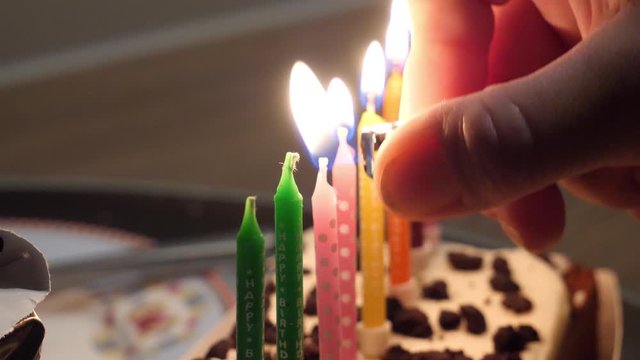 Lighting candles on a child's birthday cake for the party and celebration