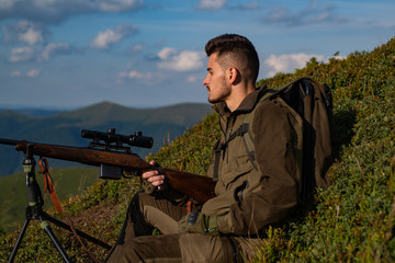 Hunter with a hunting rifle gun in the autumn forest. Hunting in America. Hunting in spring forest.