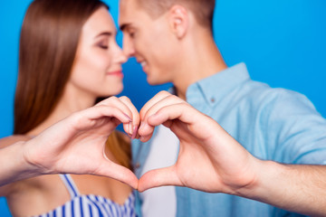 Cropped close-up portrait of her she his he two nice attractive charming cheerful tender gentle people showing heart symbol cuddling isolated over bright vivid shine vibrant blue color background