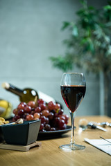 Pouring wine into glass and food background