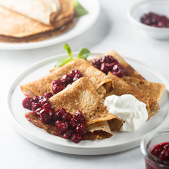 Homemade crepes with cherry sauce
