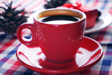 Espresso coffee in red cup lay on tablecloth