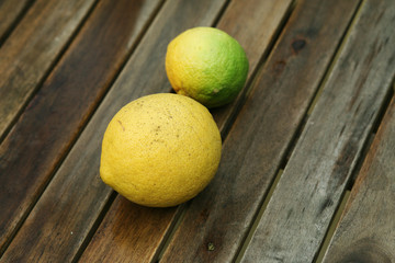 Bright fresh lemons on wooden table
