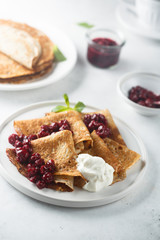 Homemade crepes with cherry sauce