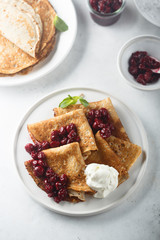 Homemade crepes with cherry sauce
