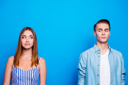 Portrait of his he her she two nice-looking attractive lovely cute charming curious people looking at each other isolated over bright vivid shine vibrant blue turquoise color background