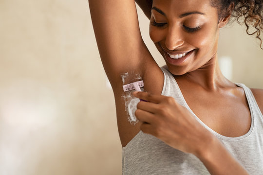 Black woman shaving armpit
