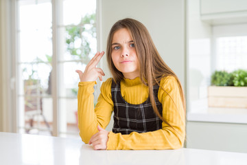 Young beautiful blonde kid girl wearing casual yellow sweater at home Shooting and killing oneself pointing hand and fingers to head like gun, suicide gesture.