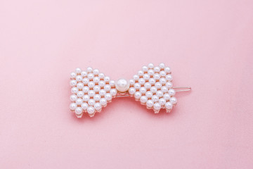 Luxury hair clip on pink fabric with copyspace.