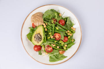 Healthy natural food. Salad with green vegetables, vitamins on the plate.