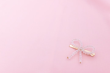 Luxury crystal hair clip on pink fabric with copyspace.