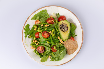 Healthy natural food. Salad with green vegetables, vitamins on the plate.