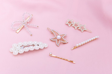 Luxury hair clips on pink fabric with copyspace.