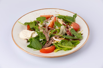 fresh salad with meat, spinach, tomato and sauce