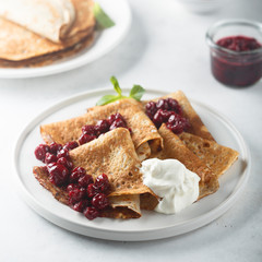 Homemade crepes with cherry sauce