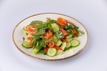 Various fresh mix salad with salmon, tomato, cucumber, onion, bell pepper, healthy food and diet menu.