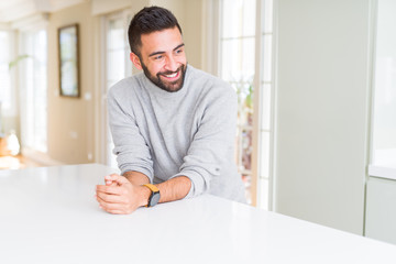 Handsome man smiling cheerful with a big smile on face showing teeth, positive and happy expression