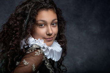 Portrait of a teen girl with long dark curly hair wearing a ruffled collar and  dress in vintage...