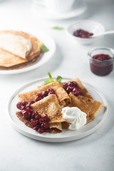 Homemade crepes with cherry sauce