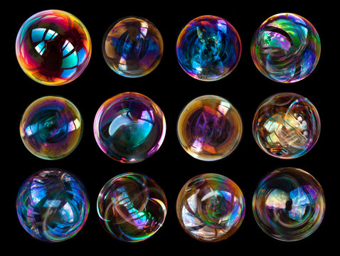 Group of soap bubbles isolated on black background.