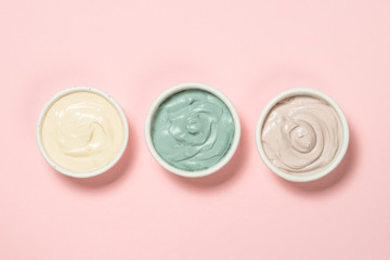 Clay mask on pink bakground, skincare product.