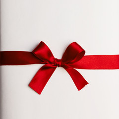 Red gift bow on white