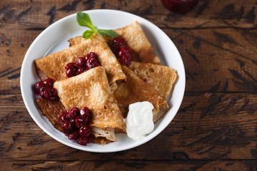Homemade crepes with cherry sauce