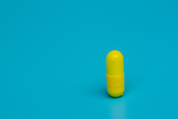 Yellow pills on blue background