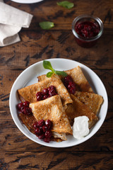 Homemade crepes with cherry sauce