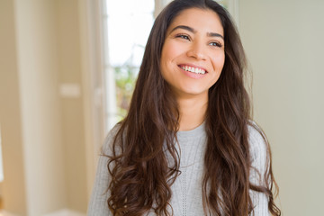 Beautiful brunette woman smiling cheerful, looking happy and positive