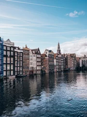 Foto op Aluminium  The iconic rows of houses near the water in Amsterdam. © SmallWorldProduction