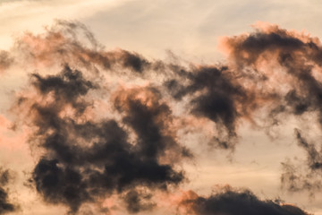 Beautiful orange sunstet with heavy or black clouds on fiery sky.