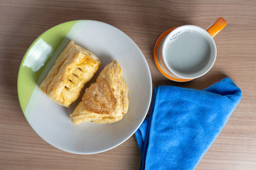 breakfast with cup of fresh milk and croissants