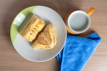breakfast with cup of fresh milk and croissants