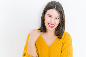 Beautiful brunette young woman smiling confident and cheerful over isolated white background wearing casual yellow sweater