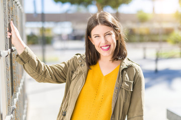 Fototapeta premium Beautiful young woman smiling cheerful walking on the street on a sunny day, casual pretty girl at the town