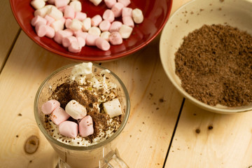 Hot chocolate drink decorated with cream, chocolate and marshmallows